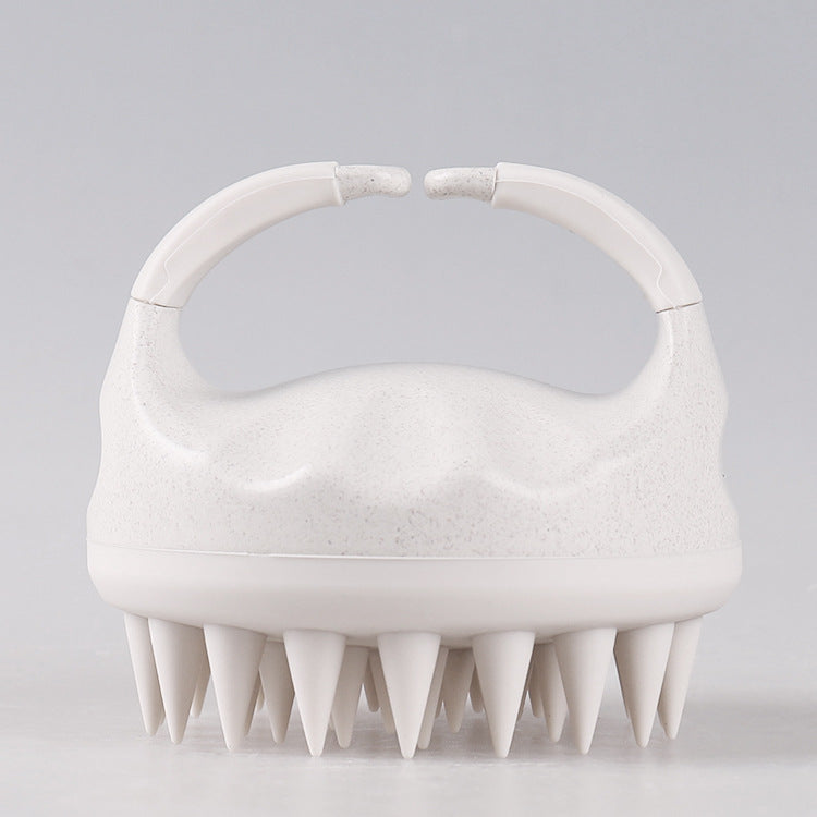 Deamira ScalpGlow hoofdhuidmassager in de hand, ergonomisch handvat